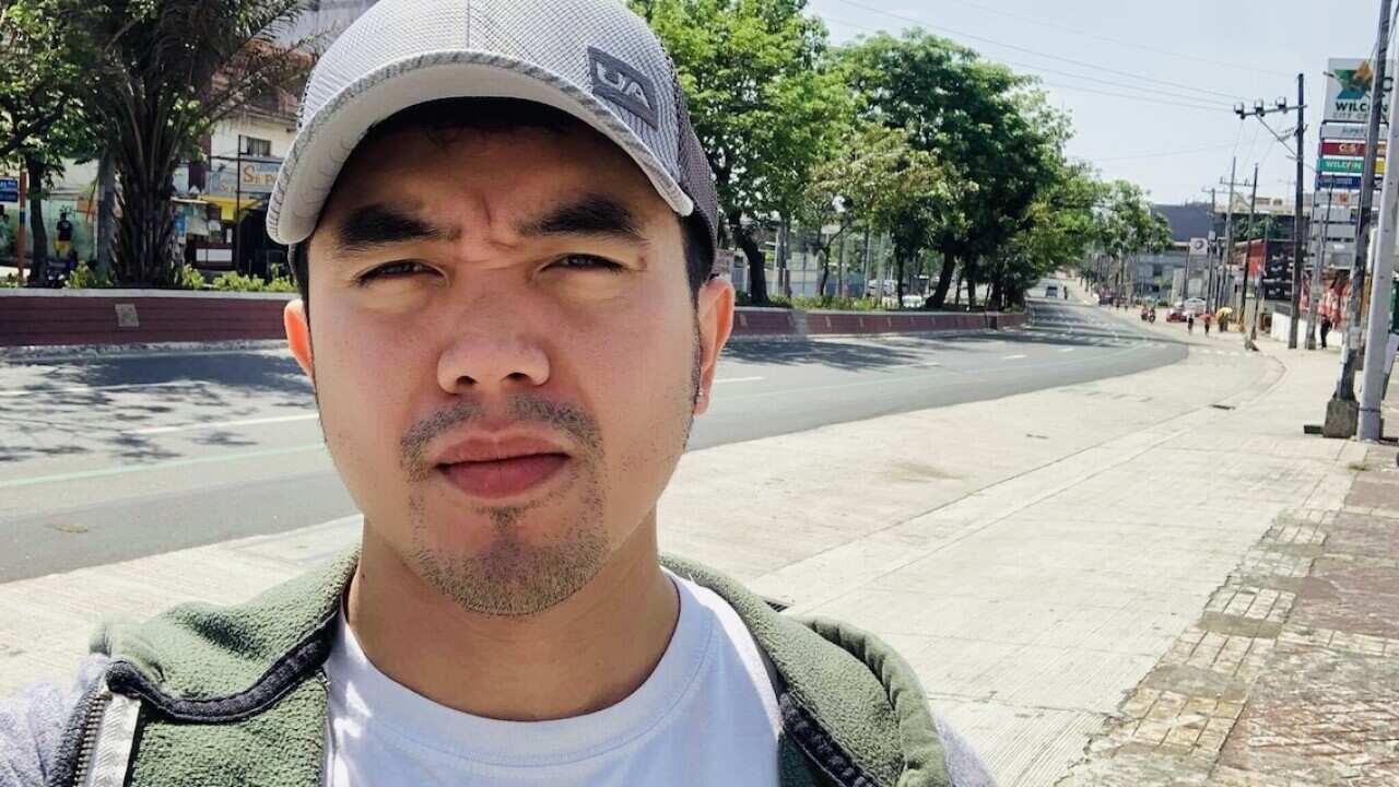 Vlogger EJ Ortiz stands at an empty street in Quezon City after a lockdown was ordered by the Philippine government last Monday.