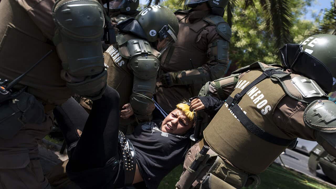 rotesters clash with police during a demonstration in O'Higgins Park in Santiago, Chile on January 16, 2018 against the visit of Pope Francis.