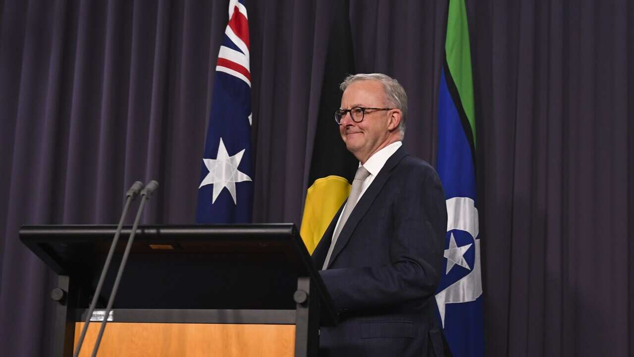 The Australian flag, the Aboriginal flag and the flag of the Torres Straits Islands are seen behind Australian Prime Minister Anthony Albanese during his press conference at Parliament House in Canberra, Monday, May 23, 2022. (AAP Image/Lukas Coch) NO ARC