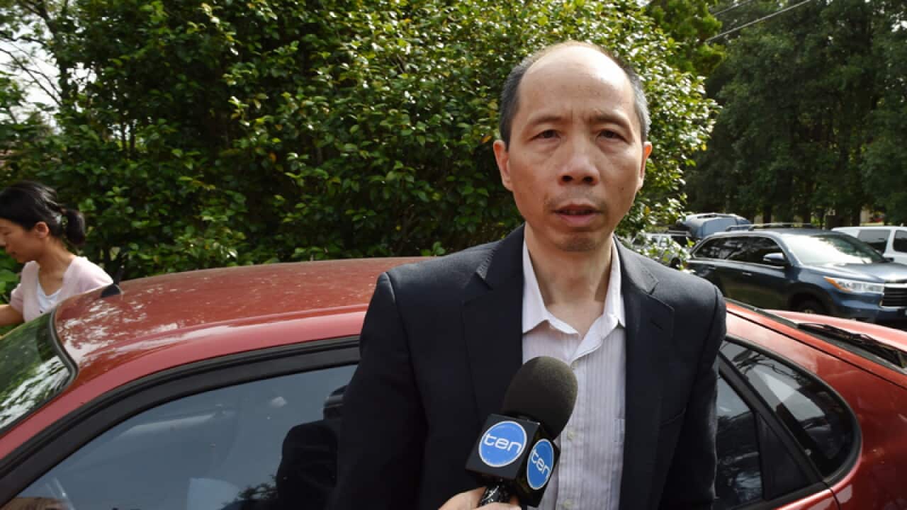 Lian Bin 'Robert' Xie arrives home with his wife
