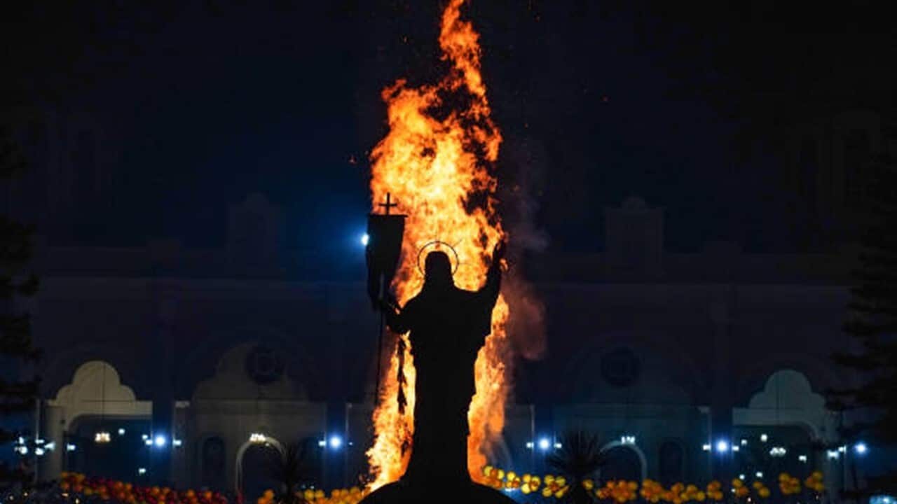 The Chibo or Demera as it also called, is set ablaze in front of a statue of Jesus Christ.jpg