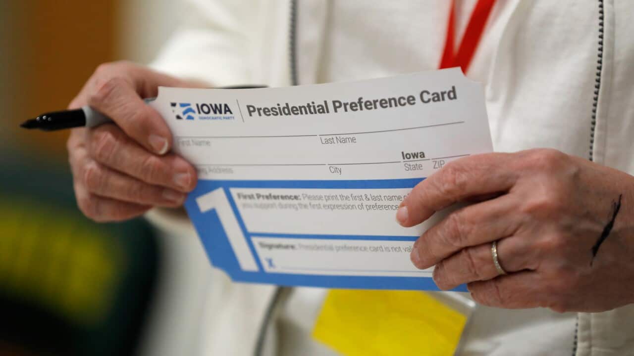 A volunteer holds a Presidential Preference Card before the start of a Democratic caucus in Des Moines, Iowa