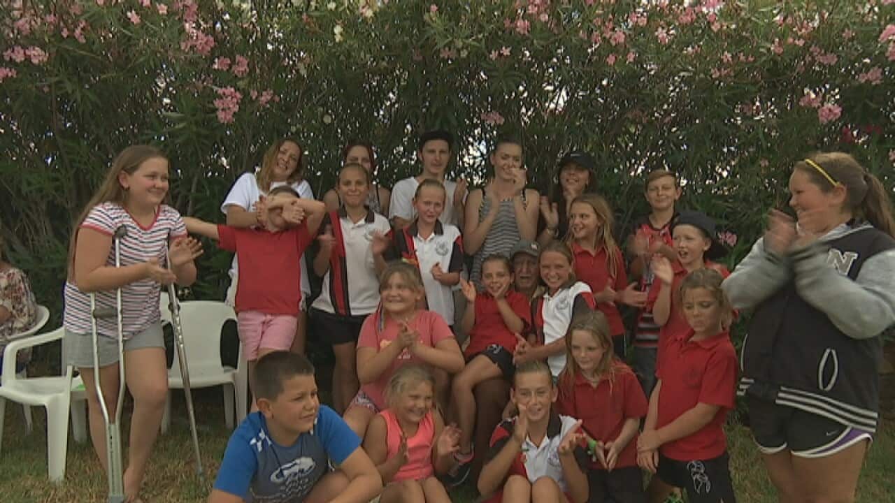 Joe Vrtacnik lost in a crowd of his grandchildren in Lightning Ridge, NSW.