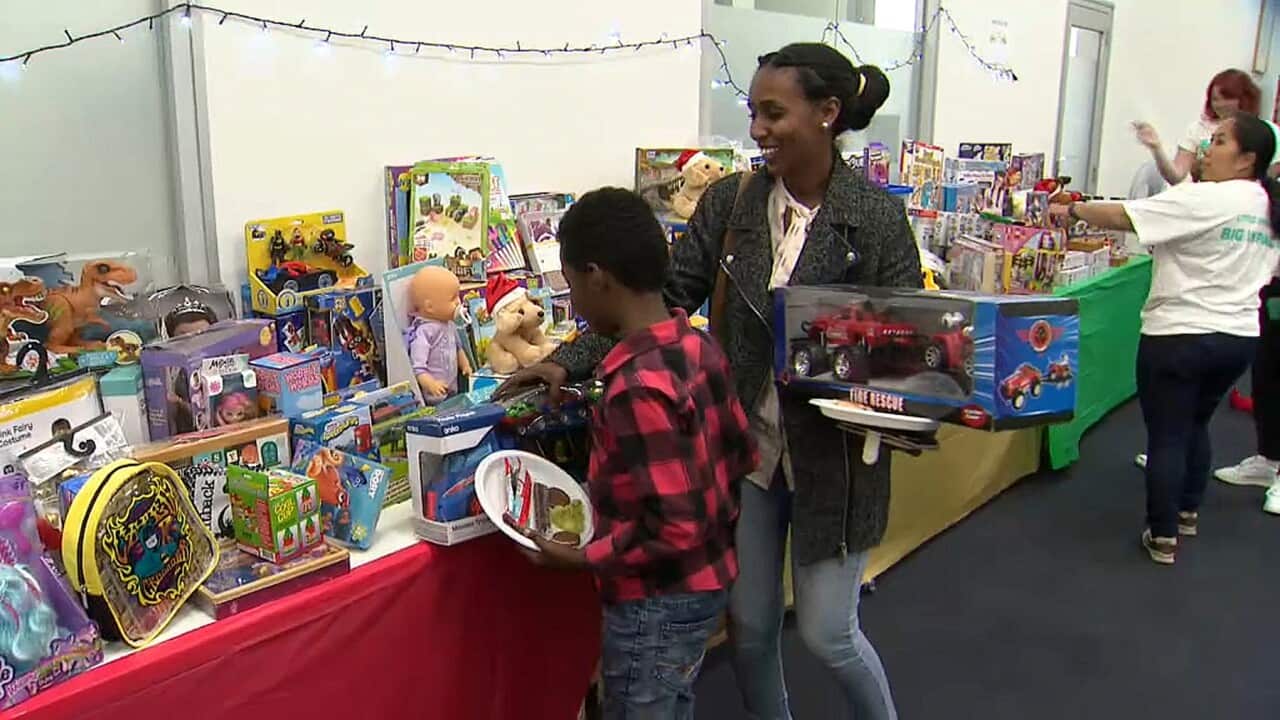 Children receiving their Christmas gifts