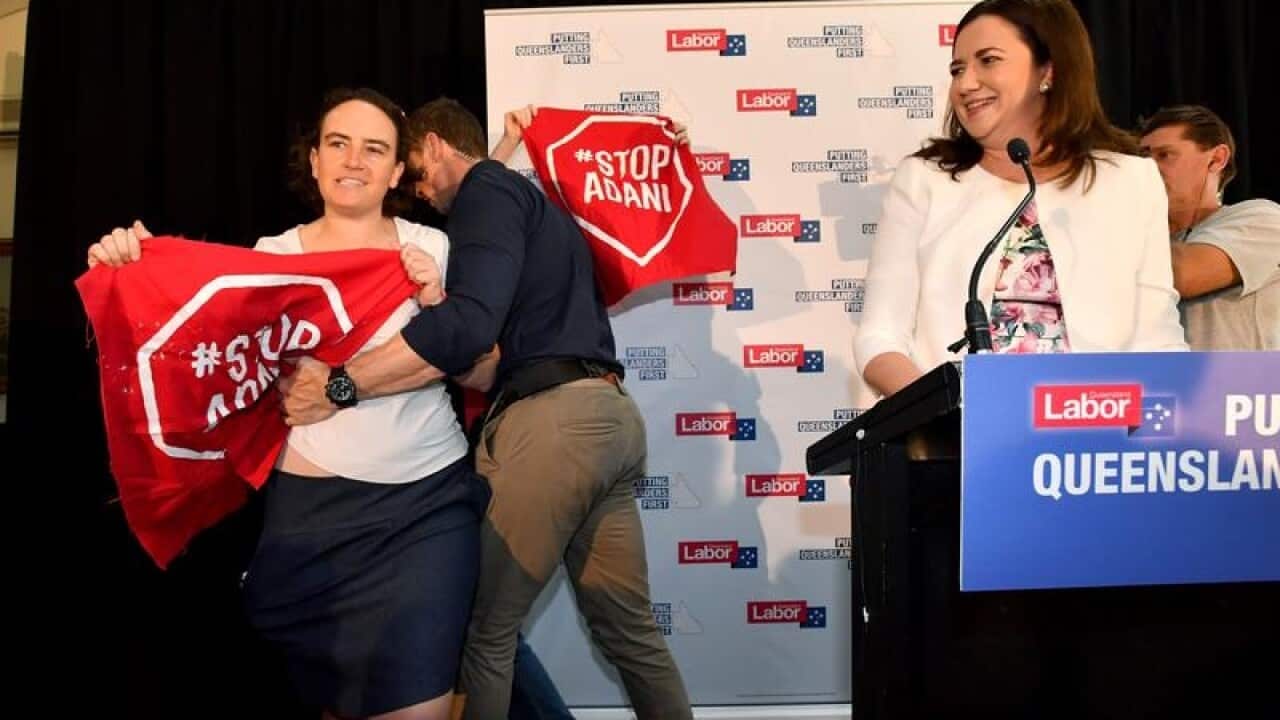 Queensland Premier Annastacia Palaszczuk reacts to protesters.