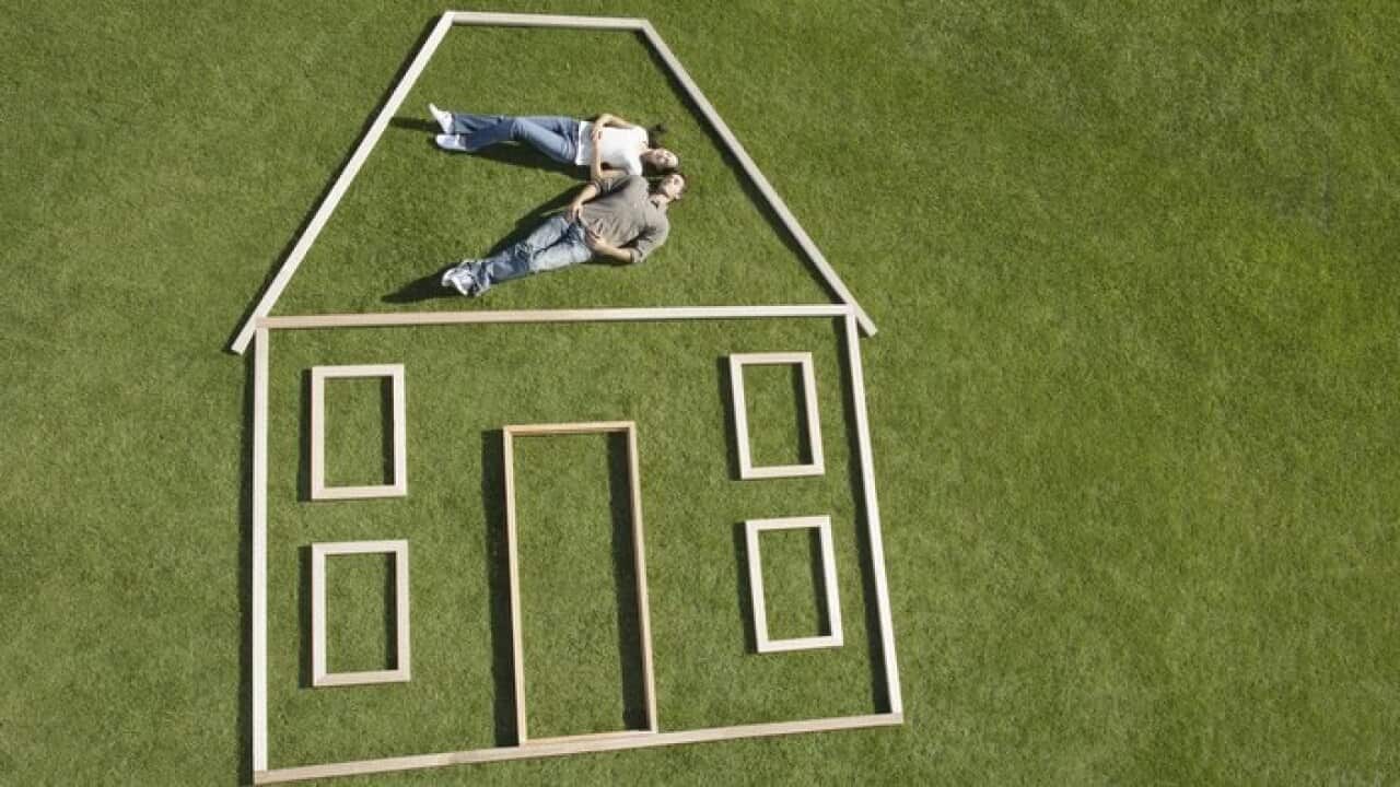 Couple laying inside house outline