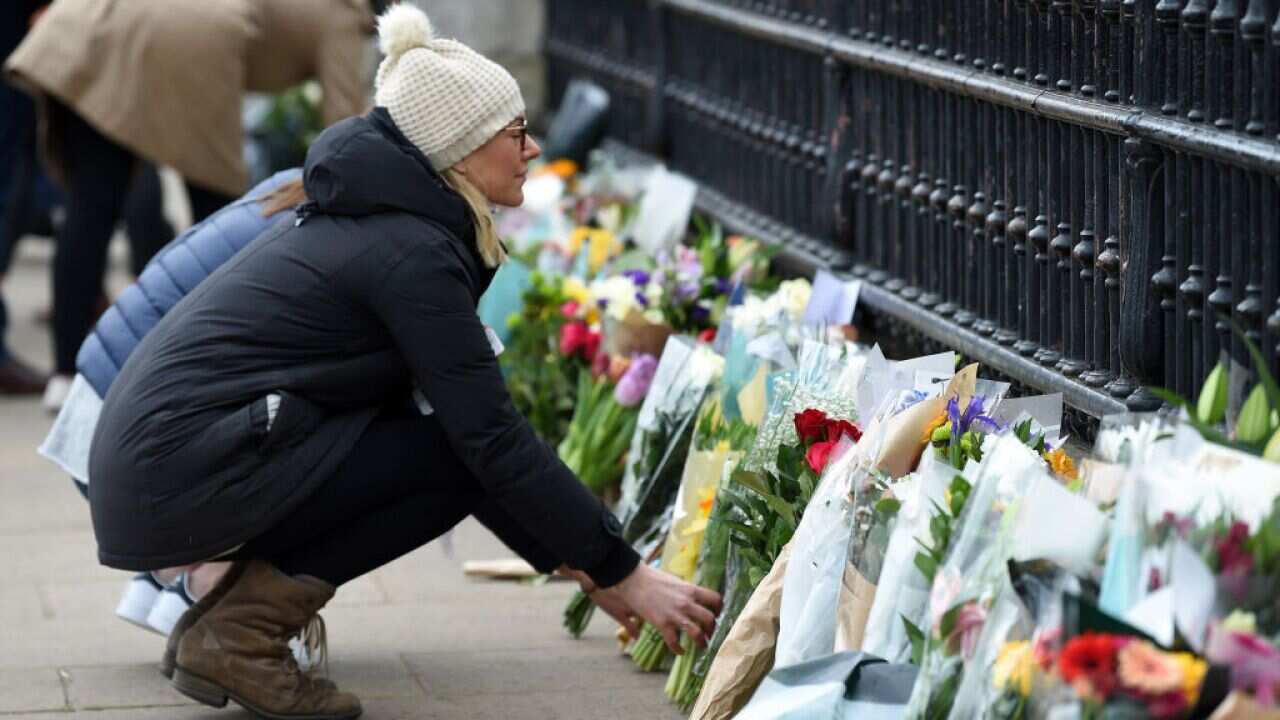 Members of the public lay floral tributes to Prince Philip, Duke Of Edinburgh who died at age 99 outside Buckingham Palace on 10 April, 2021.