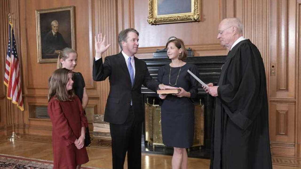 Retired Justice Anthony M. Kennedy administers the Judicial Oath to Judge Brett Kavanaugh in the Justices' Conference Room of the Supreme Court Building.