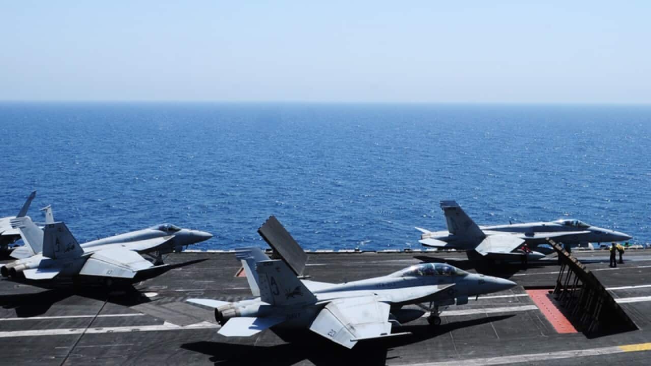 Sailors launching aircraft from the carrier USS George H.W. Bush