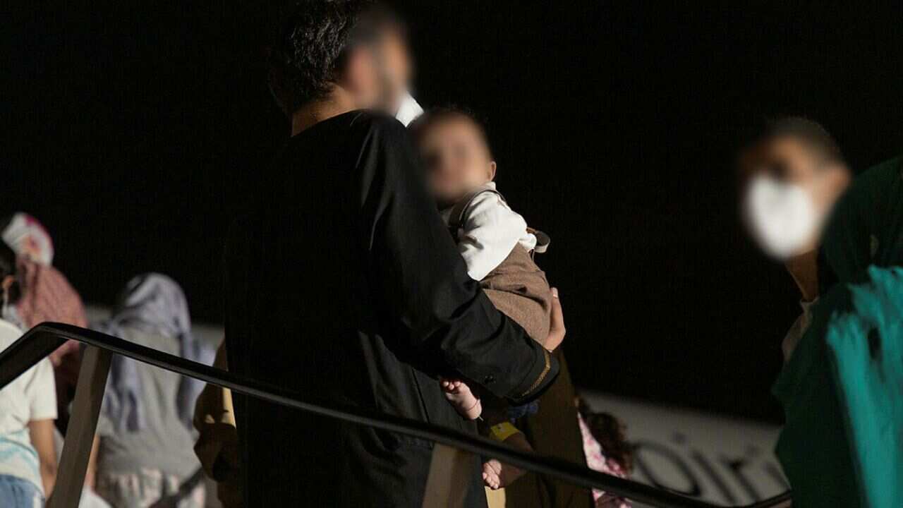 Afghanistan evacuees at Australia's main operating base in the Middle East board a Qantas B787-9 Dreamliner aircraft bound for Australia.