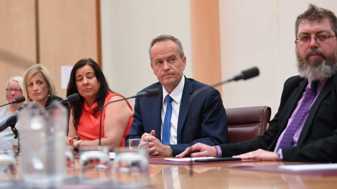 Bill Shorten listens to former employees of the banking and financial services sector during a meeting at Parliament House