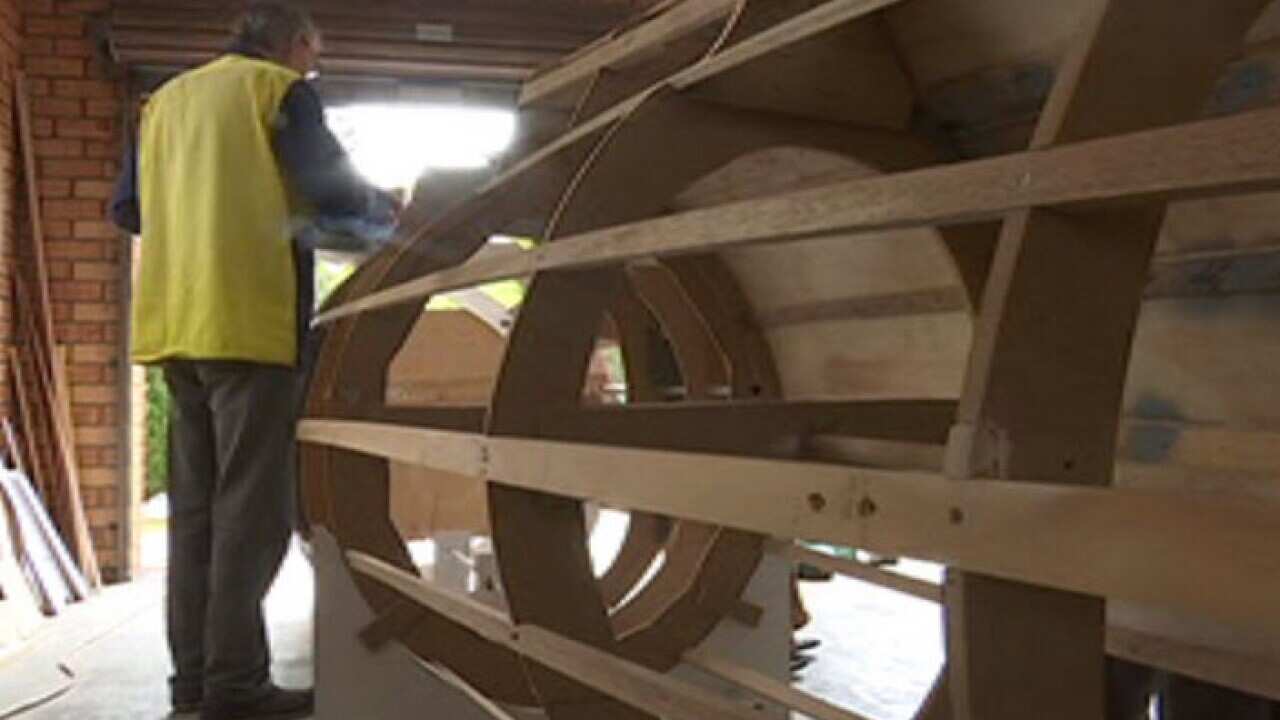 Andrew Krajewski works on the replica fighter