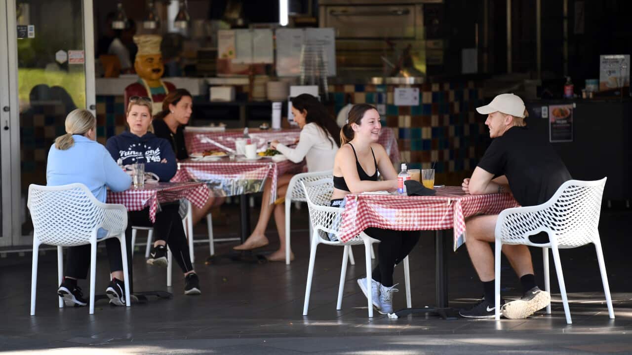 Cafe customers sit at tables distanced from each other in Southbank in Brisbane, Sunday, 17 May, 2020.