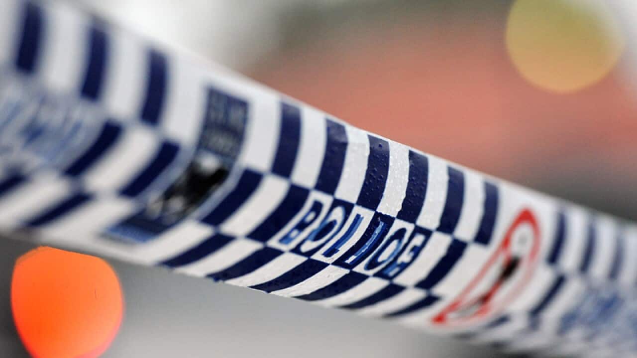 Police tape restricts access to a crime scene