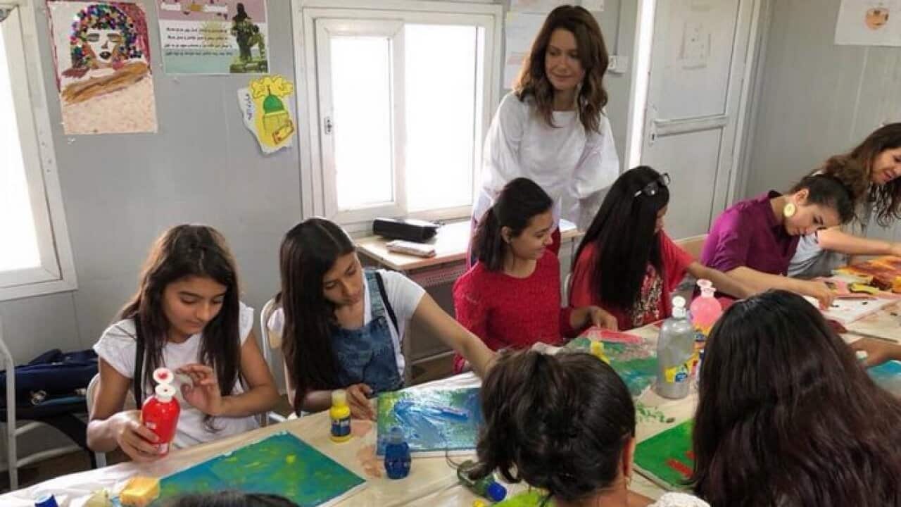 Artist Hivron Turanli with children in painting class