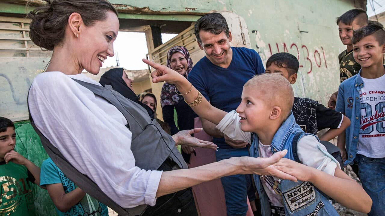 Angelina Jolie, meeting Falak, 8, during a visit to West Mosul, Iraq