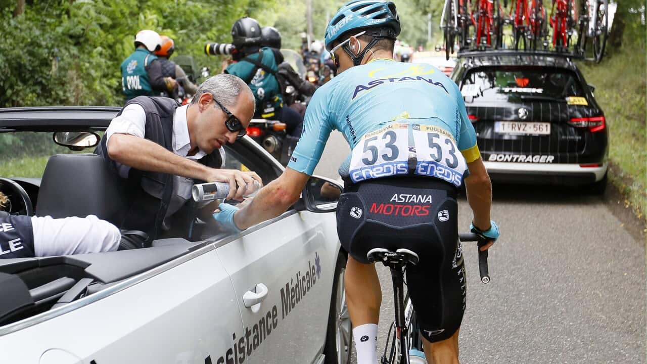 Jakob Fuglsang receiving medical assistance after a crash on stage 11 of the 201 Tour de France