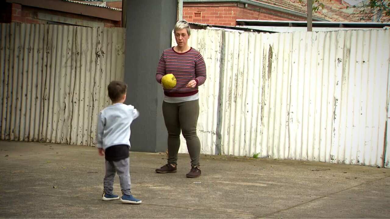 Laura playing with her son (SBS).jpg