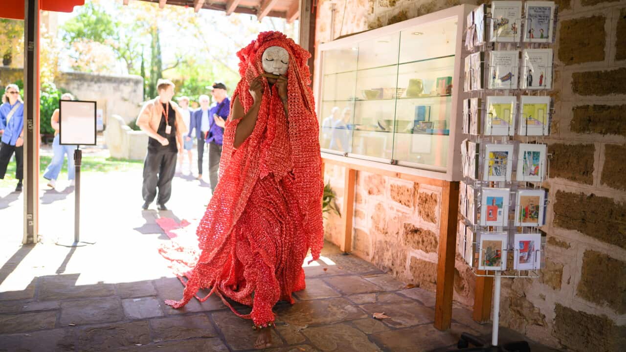 Tamarra performing a walking piece through Walyalup Fremantle Art Centre, Perth, and into Fremantle, as part of the Pasar Malam exhibition.