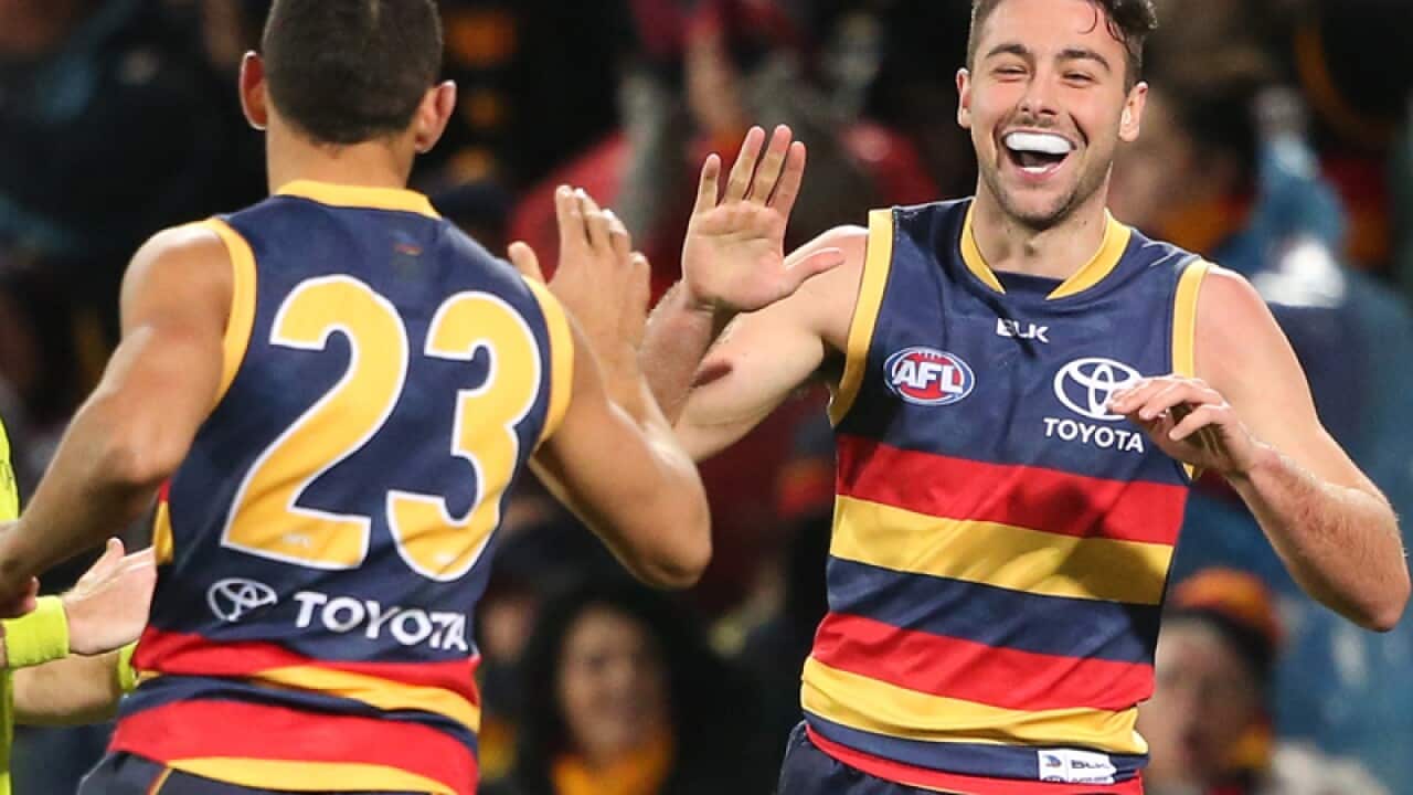 Rory Atkins of the Crows is congratulated by Charlie Cameron