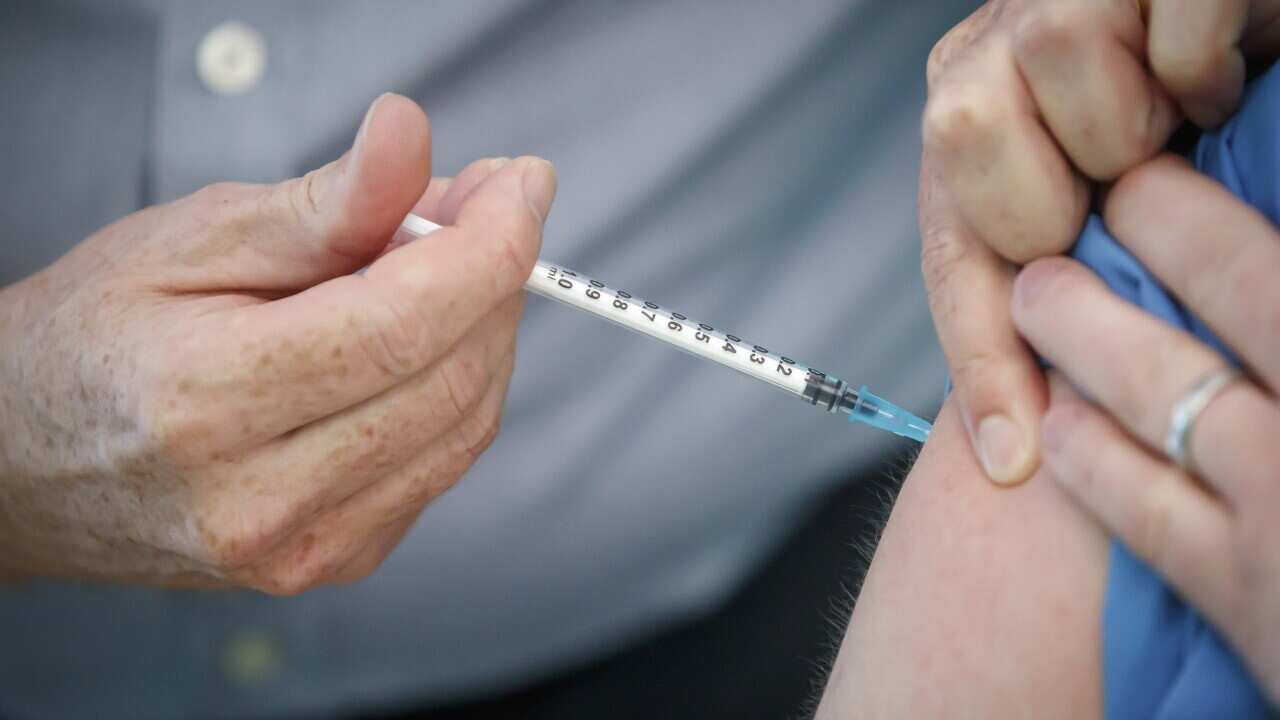 A person receiving the Pfizer-BioNTech COVID-19 vaccine at a vaccination centre in New York.