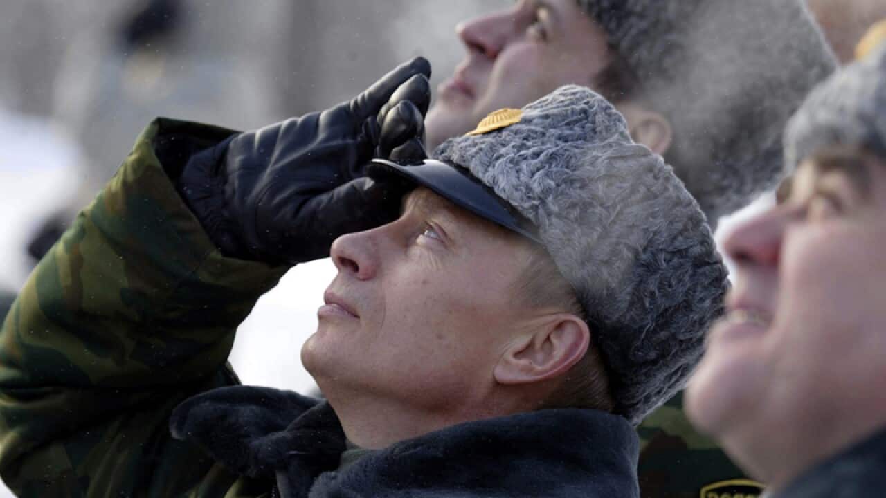 Russian President Vladimir Putin watches a launch of a Russian rocket