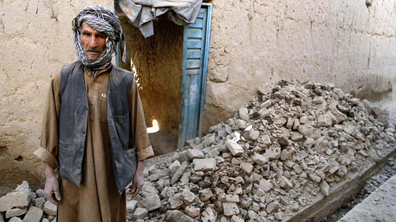 A man stands outside his damaged home a day after a 7.7 magnitude earthquake in Parwan, Afghanistan, 27 October 2015.(EPA)