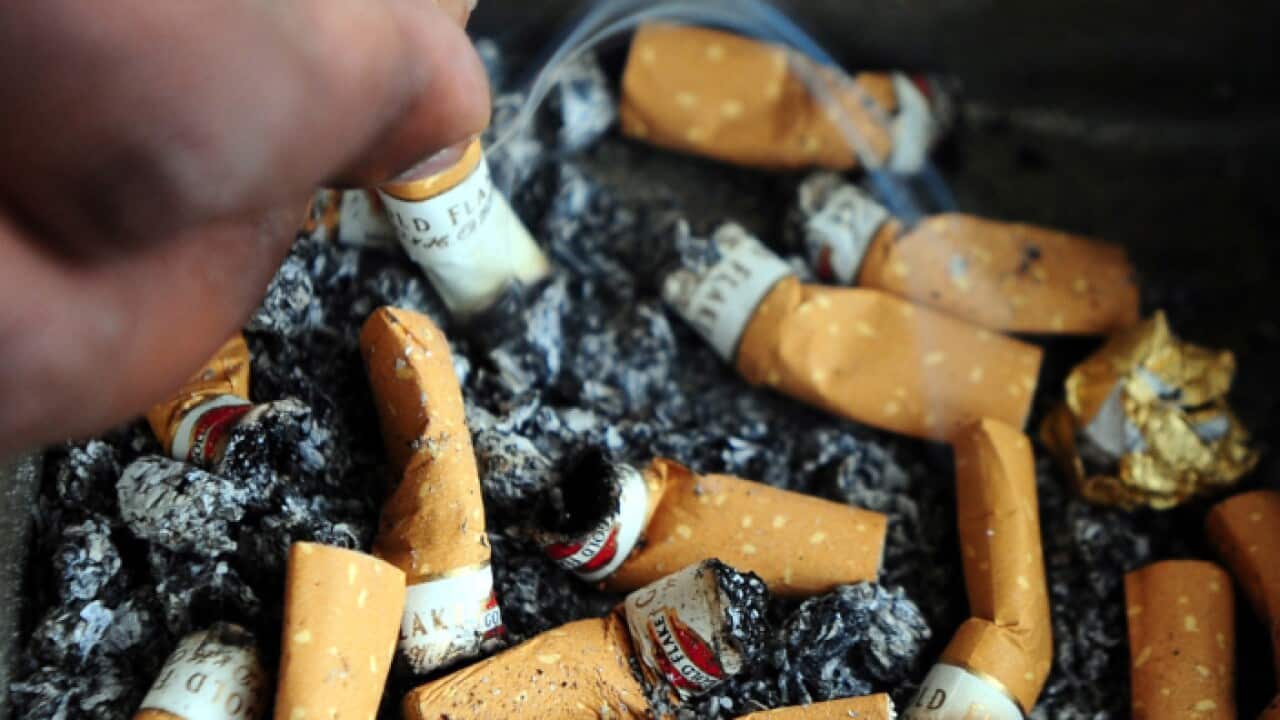 An Indian man stubs out a cigarette, in the Southern Indian city of Bangalore