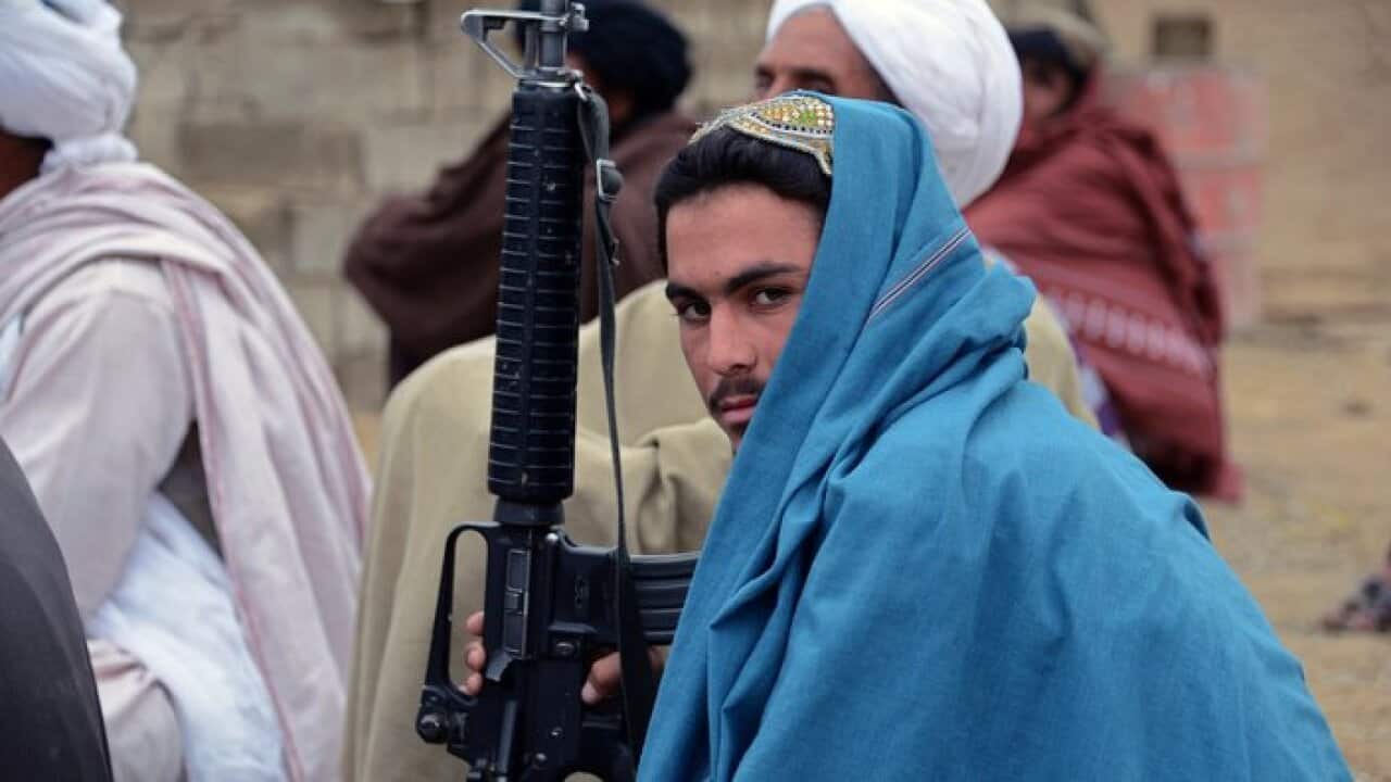 In this photograph taken on November 3, 2015, an Afghan Taliban fighter looks on as he listens to Mullah Mohammad Rasool Akhund (unseen).