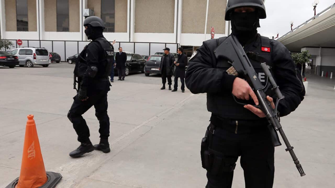 Tunisian policemen stand guard at Carthage Airport in Tunis