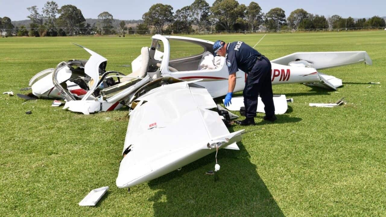Two people are dead after a light plane crash in southeast Queensland with photos from the scene showing the wreckage lying on grass.