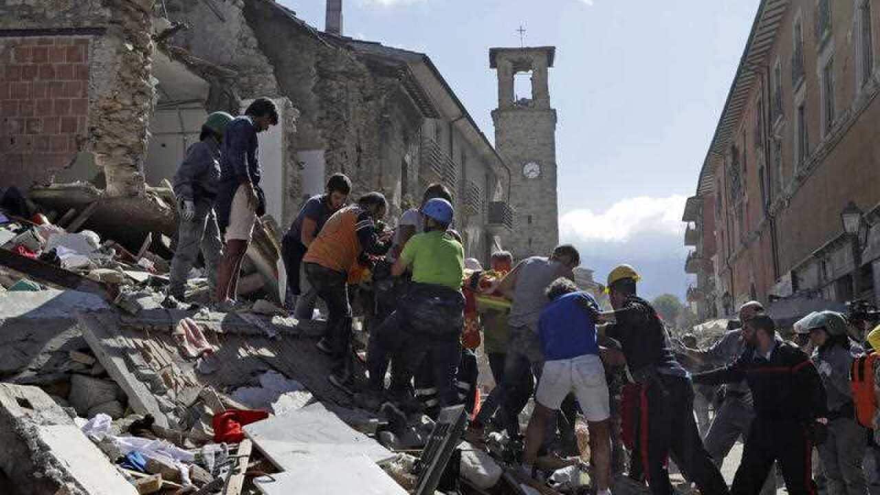 A victim is carried on a stretcher from a collapsed building after an earthquake, in Amatrice, central Italy, Wednesday, Aug. 24, 2016.