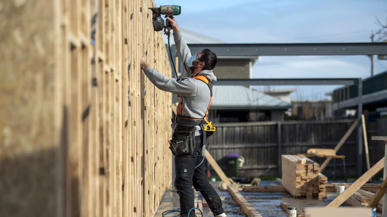 Construction worker on-site using a tool.