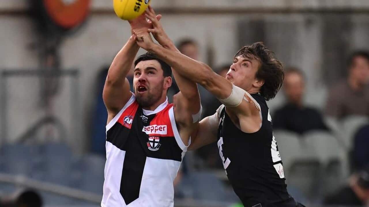 Saints' Paddy McCartin and Caleb Marchbank of the Blues in action.