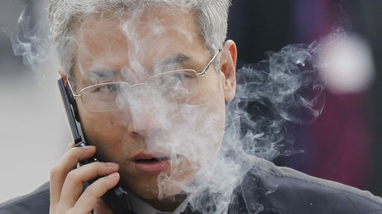 A man smokes in Beijing
