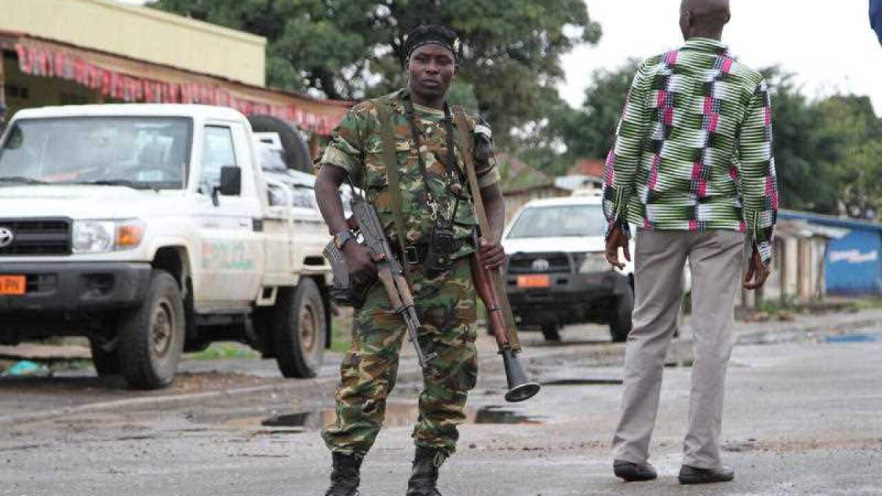 a Burundian soldier with his gun and rocket launcher guard a deserted street in Bujumbura, Burundi.