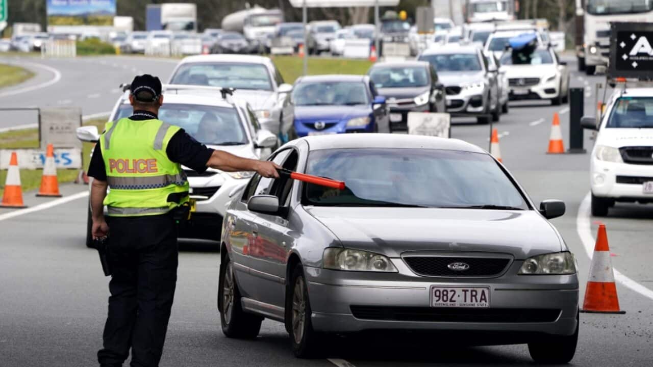Motorists are seen approaching a checkpoint at Coolangatta on the Queensland- New South Wales border, Friday, August 7, 2020