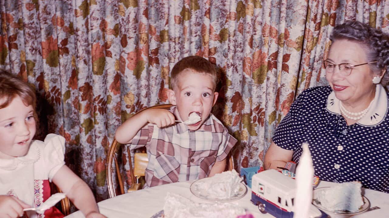 Grandchildren eating with grandmother