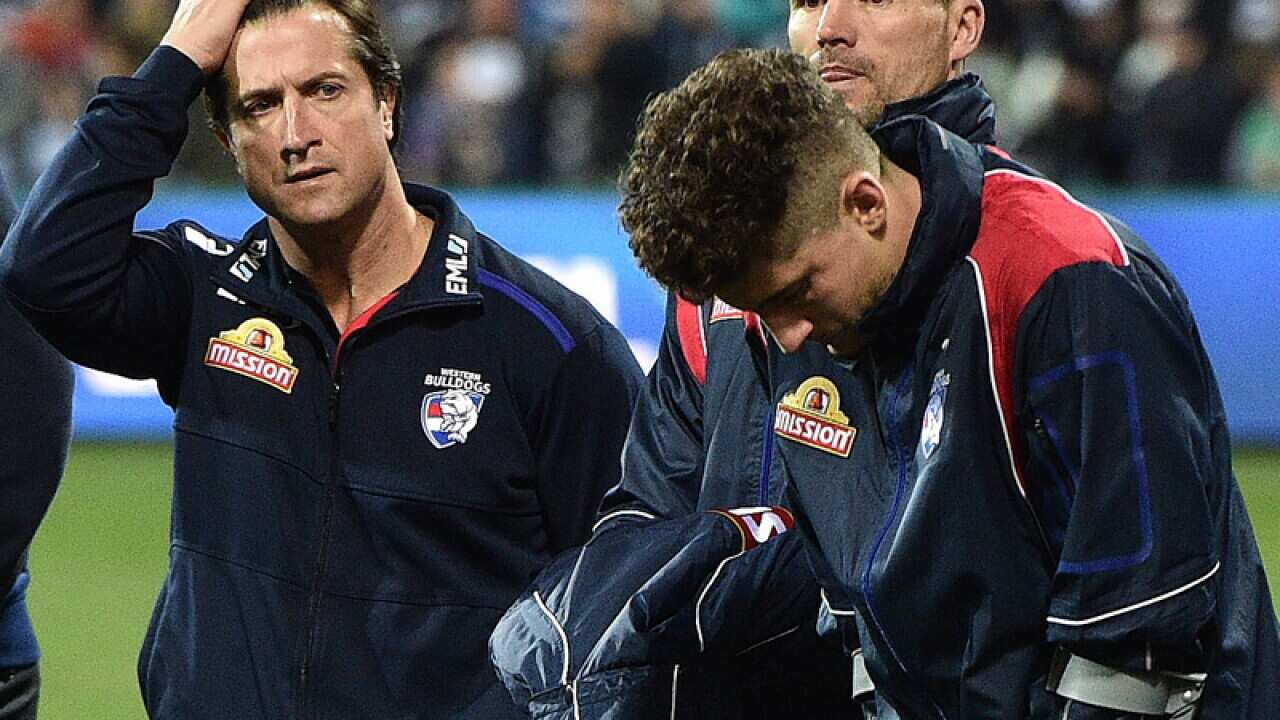 Luke Beveridge (left) looks towards Tom Liberatore