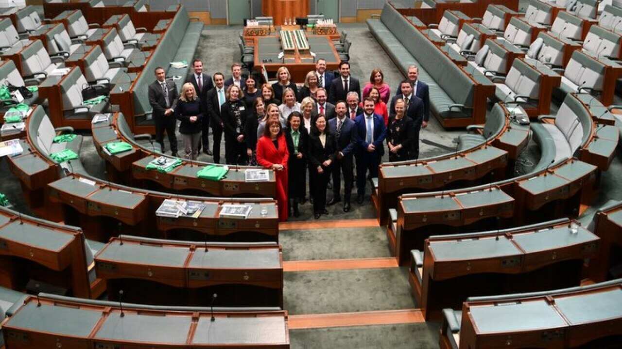 Newly elected MPs pose for photographs in the House of Representatives in Canberra