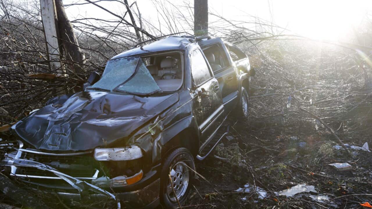 A vehicle sits among debris near Linden, Tenn.