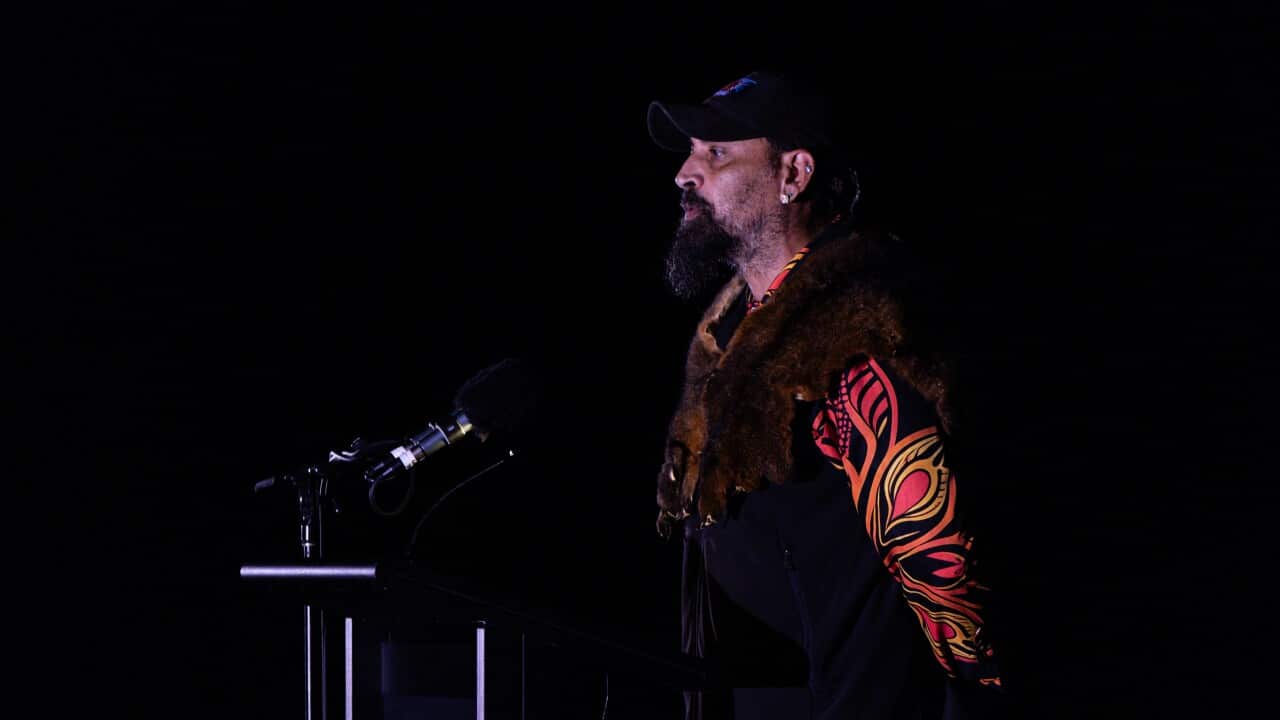 a man stands in front of a microphone