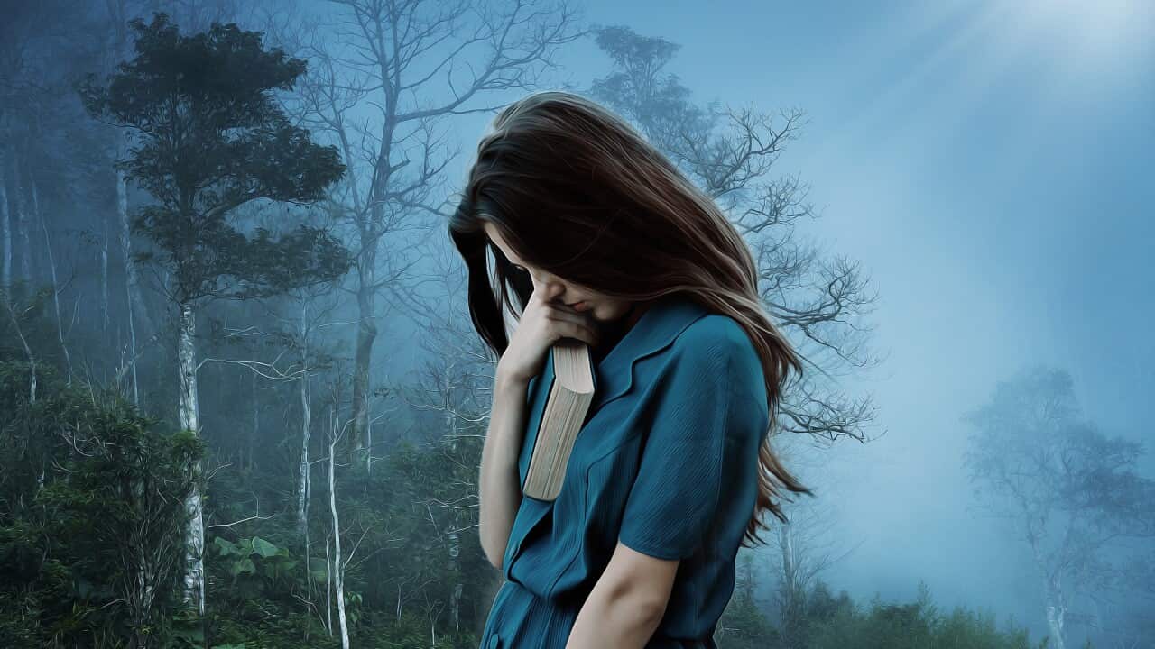 A girl holding a book in solitude