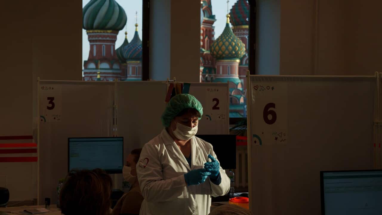 Health worker prepares vaccine