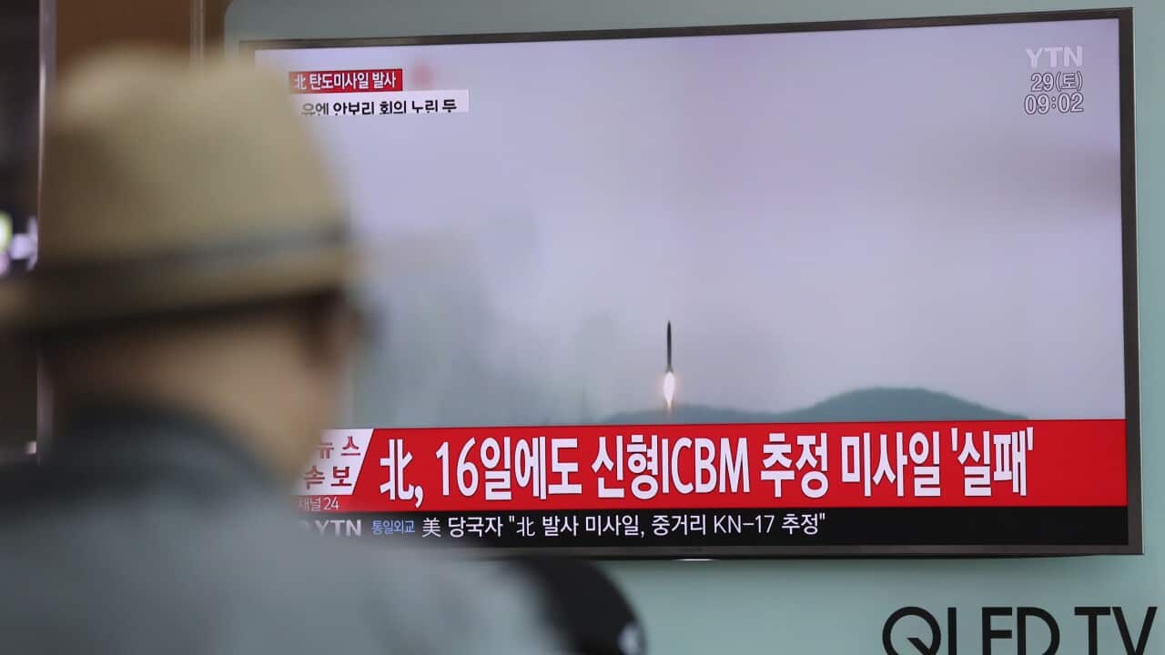 A man watches a TV news program reporting about North Korea's missile firing with a file footage, at Seoul Train Station in Seoul, April 29, 2017.