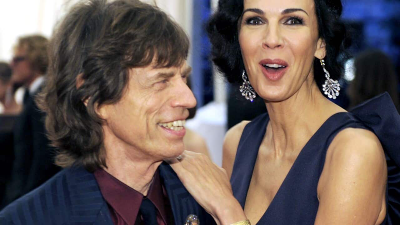 Mick Jagger (L) and L'Wren Scott