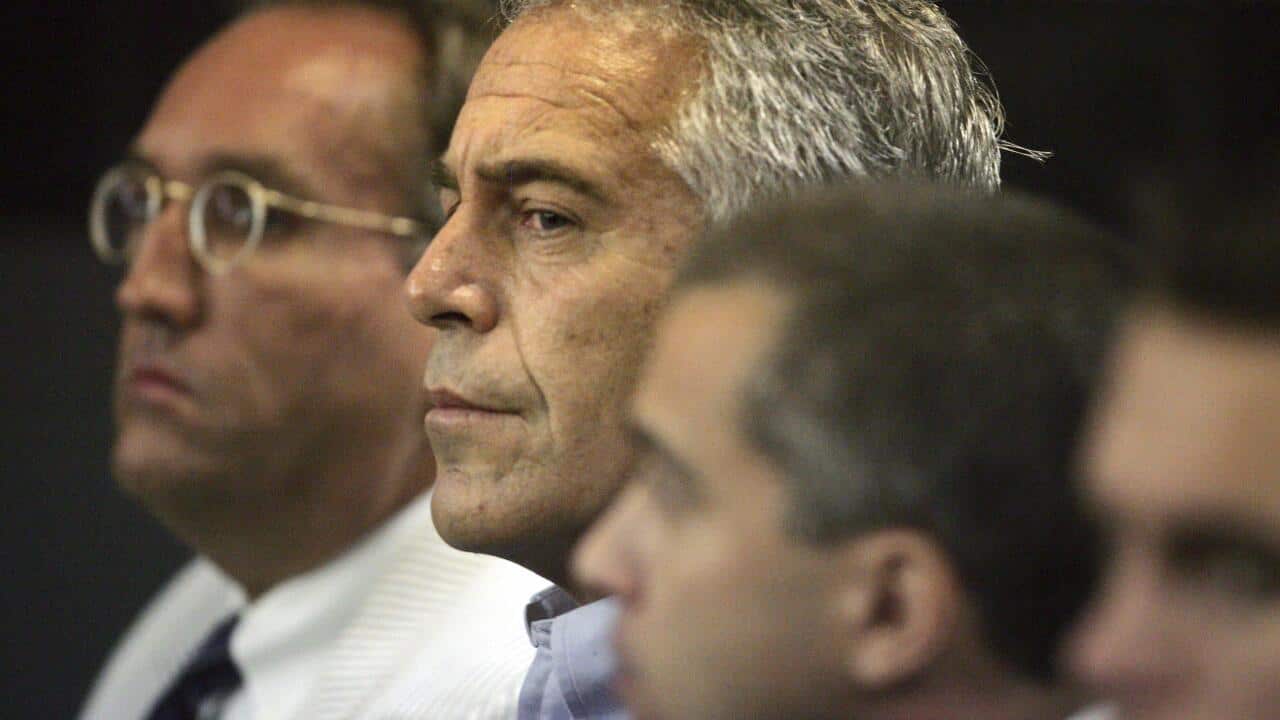 Jeffrey Epstein (center) in a Palm Beach County courtroom on July 30, 2008.