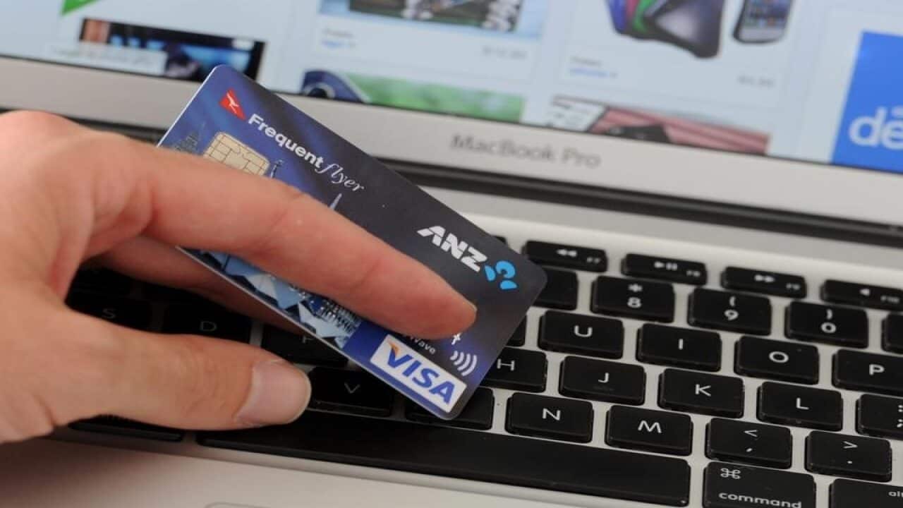 A credit card in front of an online shopping site
