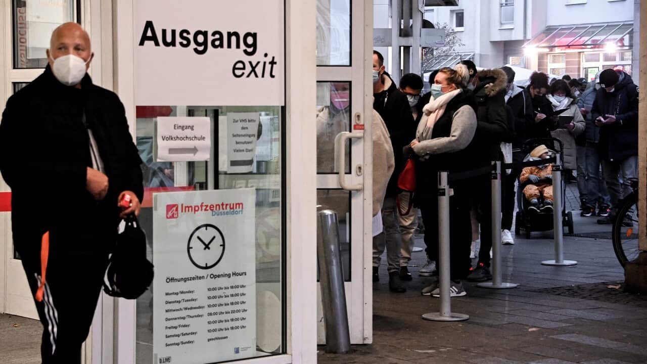 People queue for Covid-19 coronavirus vaccination at the main station vaccination centre in Duesseldorf, Germany