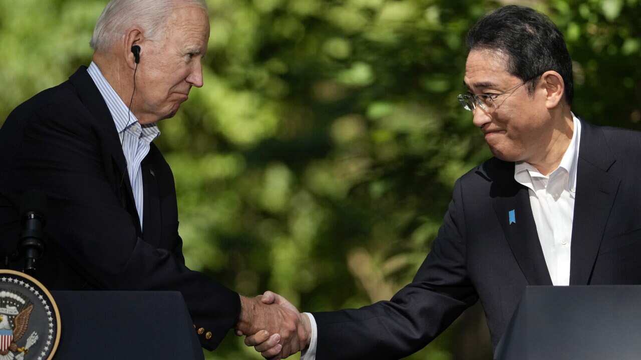 US president Joe Biden shaking hands with Japan's Prime Minister Fumio Kishida
